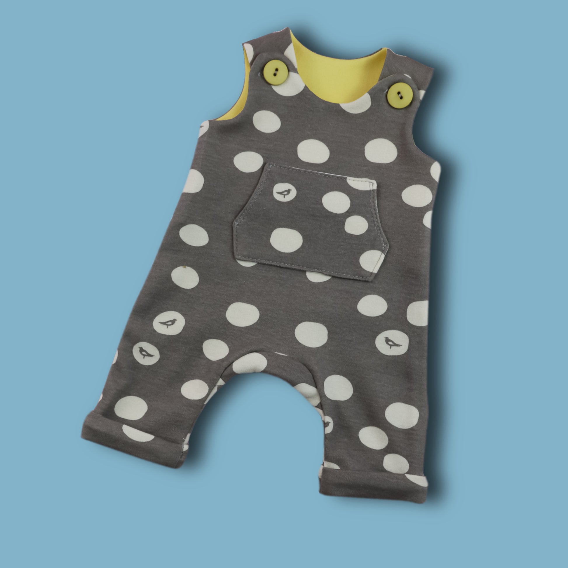 Dungies, baby romper pdf sewing pattern by Frocks & Frolics. For four way stretch interlock jersey. With gusset. Front pocket and dungaree closure. Comes with free video tutorial.