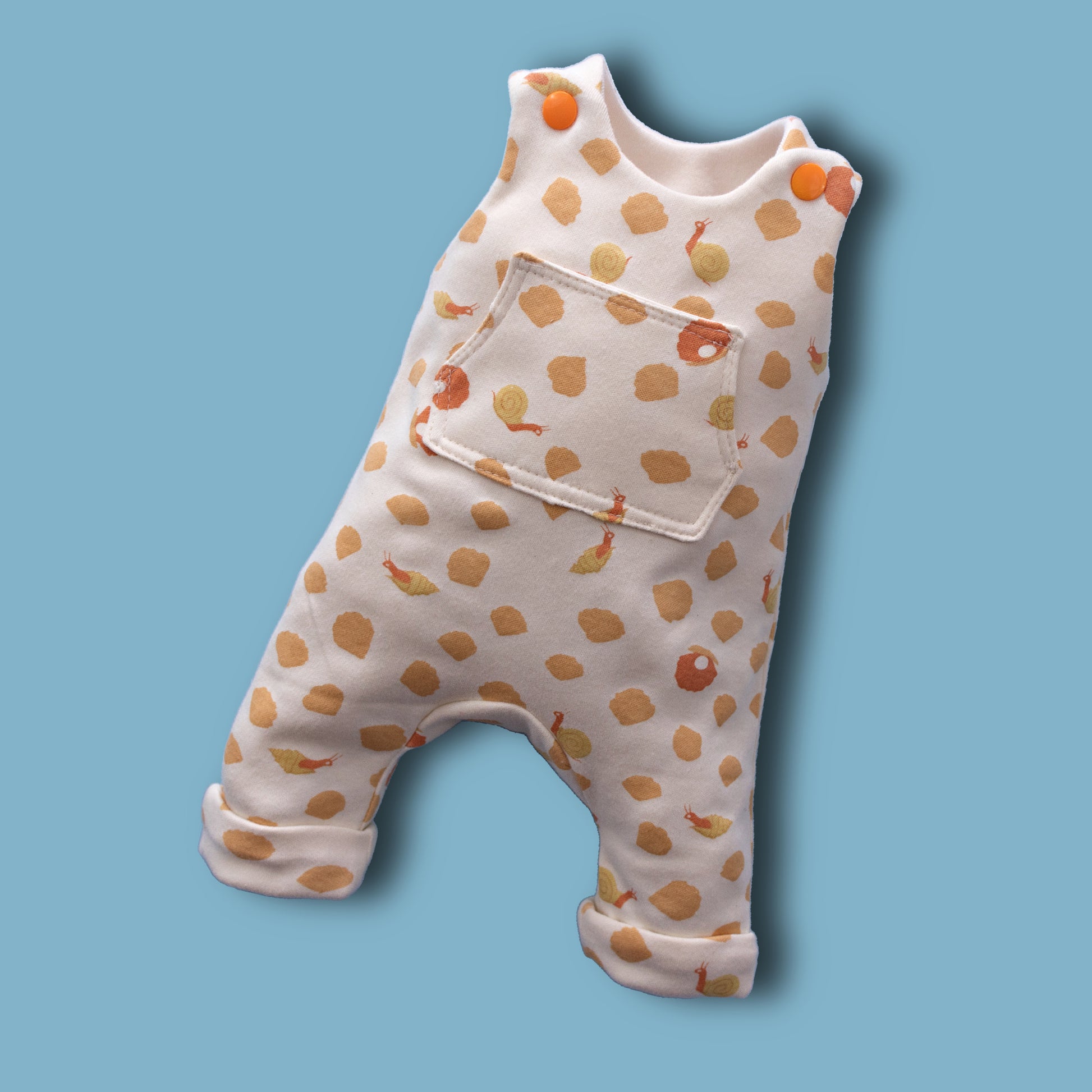 Dungies, baby romper pdf sewing pattern by Frocks & Frolics. For four way stretch interlock jersey. With gusset. Front pocket and dungaree closure. Comes with free video tutorial.