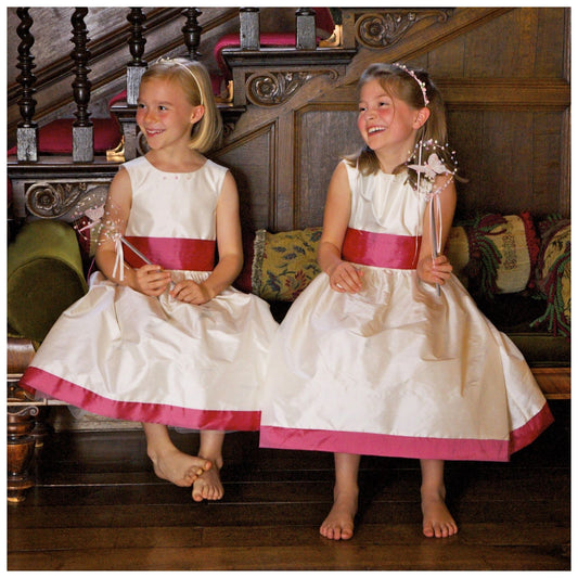 Flower girl dress pdf sewing pattern, cummerbund sash, big bow, classic flower girl frock, pink sash, cream bodice, covered buttons, rouleaux loop fastening. Free You Tube Video playlist. Back view of the handcovered cover buttons.