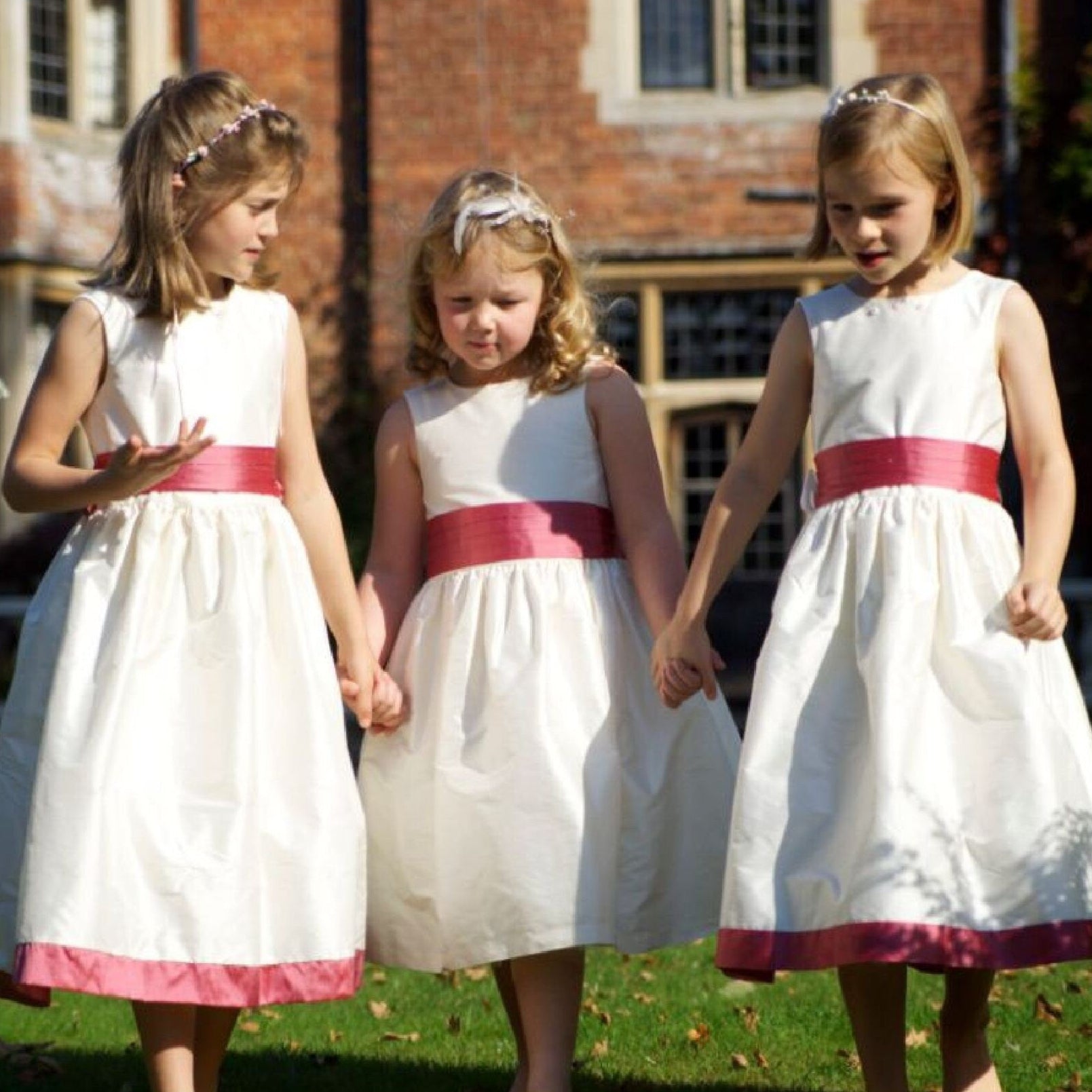 Flower girl dress pdf sewing pattern, cummerbund sash, big bow, classic flower girl frock, pink sash, cream bodice, covered buttons, rouleaux loop fastening. Free You Tube Video playlist. Back view of the handcovered cover buttons.