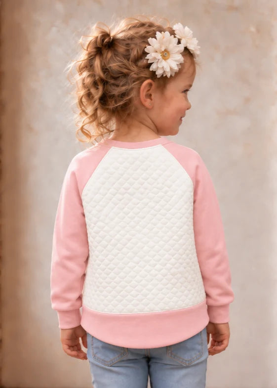Jelly Bean Sweater sewing pattern – pink and white quilted raglan sweater on a girl, back view