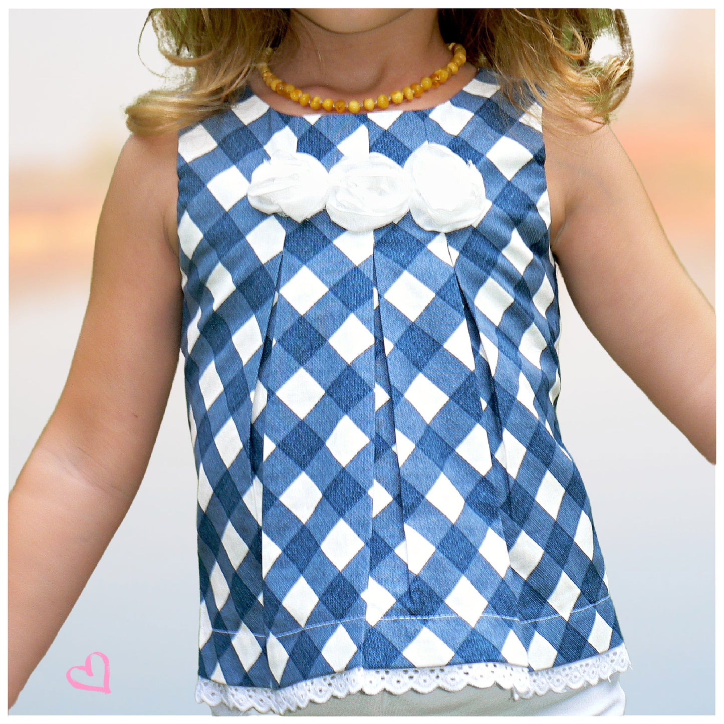 Pretty sleeveless summer dress with front pleats which open out. A-line shape, knee length. Sewing pattern and free video tutorial by Frocks & Frolics. 