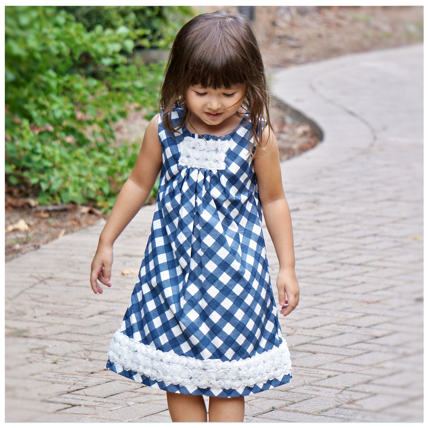 Pretty sleeveless summer dress with front pleats which open out. A-line shape, knee length. Sewing pattern and free video tutorial by Frocks & Frolics. 