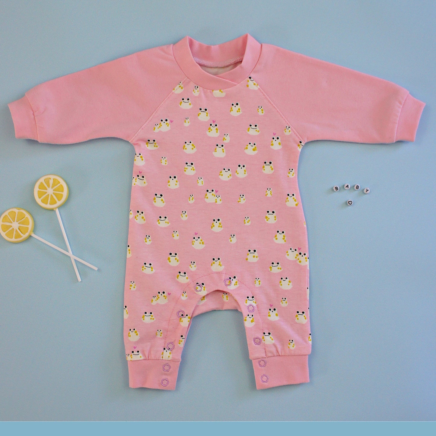 Lollipop romper, pdf sewing pattern by frocks and frolics. Raglan sleeves and full length legs with cuffs. Gusset in the inner leg seam and KamSnap closure.Teddybear print. Comes with video tutorial.