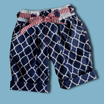 Maisy shorts pdf sewing pattern by Frocks & Frolics. Blue and white print with belt loopes, ties, side pockets and back patch pockets. The pattern includes video tutorials for every step.