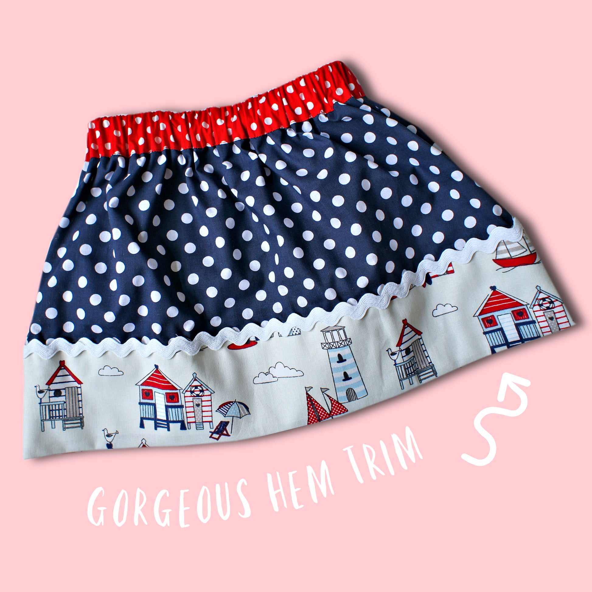 Melinda skirt, pdf sewing pattern by Frocks & Frolics. Elasticated waist with feature front panel. Hem trim with rick-rack finish.Nautical theme with white on blue polka dots and a sea side scene for the trim. Comes with video tutorial.