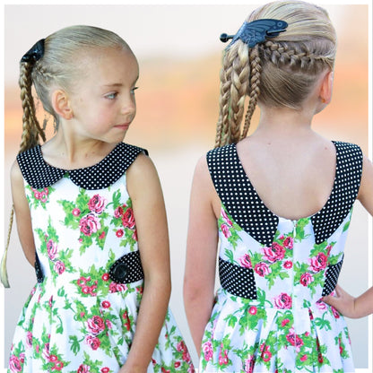 Vivienne dress for girls by Frocks & Frolics. Princess seam bodice, a sleeveless dress printed cotton. Peter Pan collar with lower cut back. Pleated skirt. Large feature tabs with oversized button. Concealed zipper. 