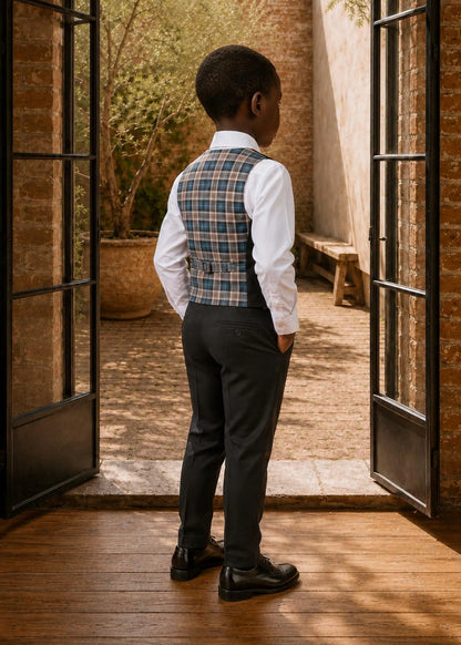 Back view of a boy wearing a plaid pattern Brooklyn waistcoat with an adjustable back buckle strap and dark dress pants.