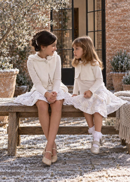 Frocks & Frolics Joanna cardigan sewing pattern – two girls in white cropped cardigans with lace and sequin skirts