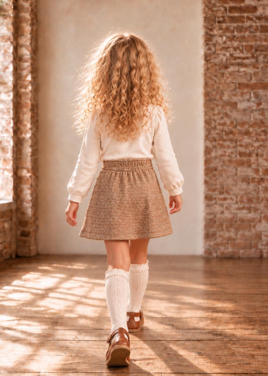 Frocks & Frolics Jutta skirt sewing pattern – back view of brown tweed skirt with cream blouse and knee socks