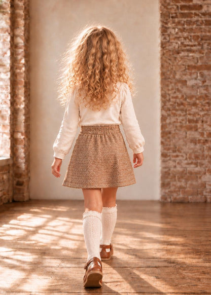 Frocks & Frolics Jutta skirt sewing pattern – back view of brown tweed skirt with cream blouse and knee socks