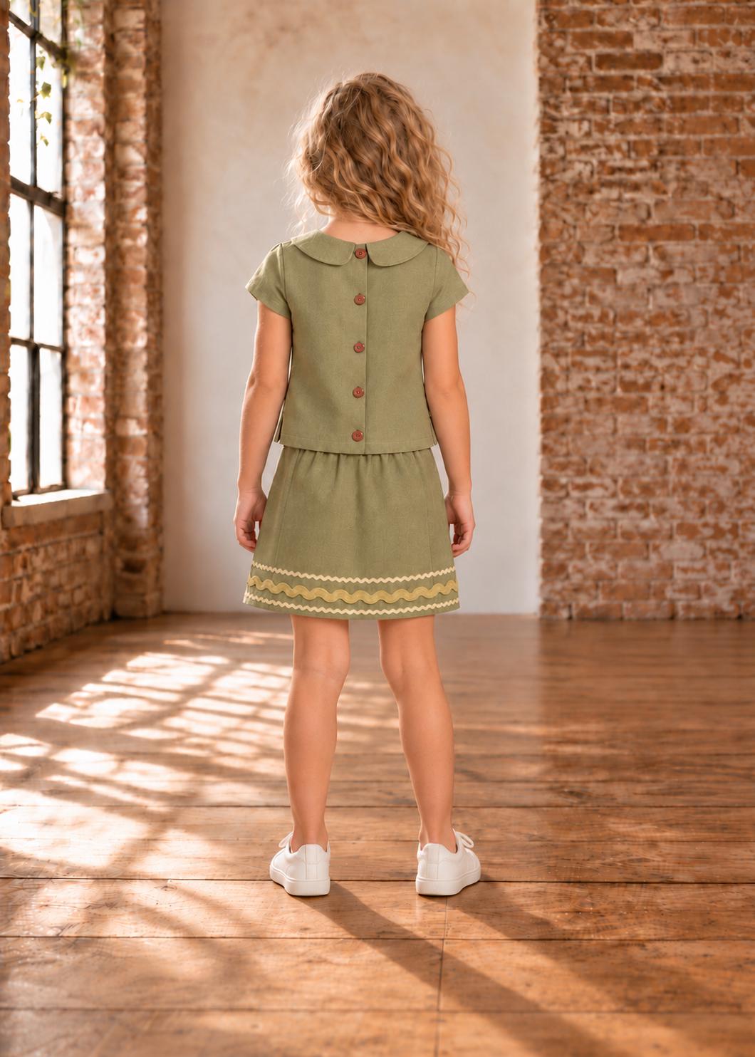 Frocks & Frolics Jutta skirt sewing pattern – back view of olive green set with wavy trim hem