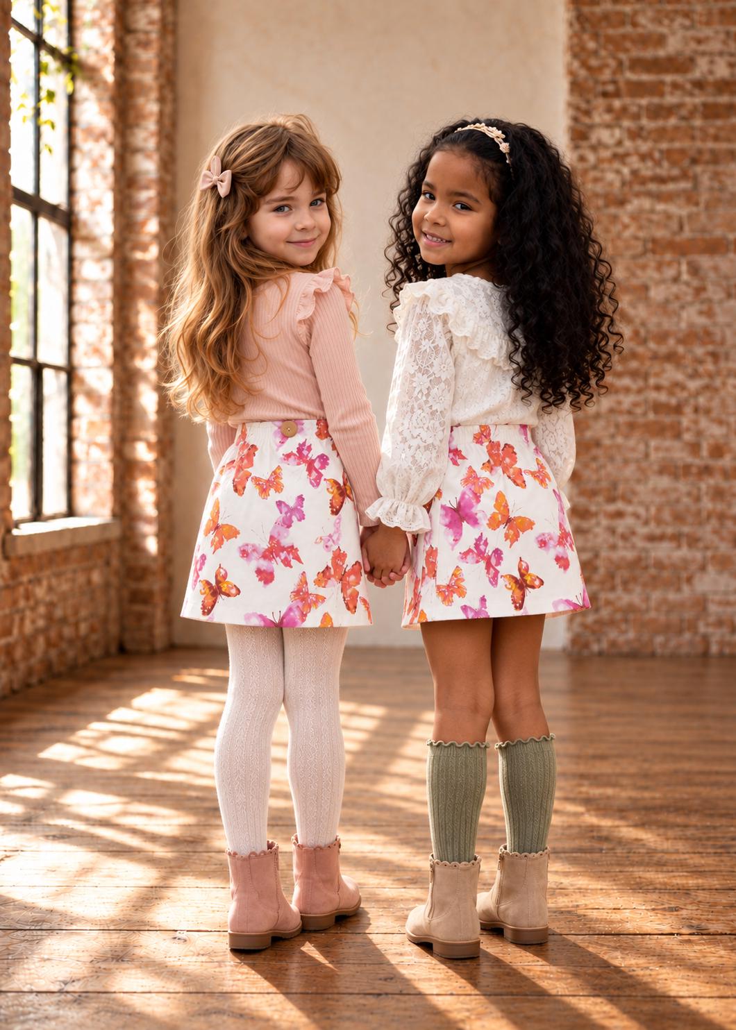 Frocks & Frolics Jutta skirt sewing pattern – two girls in white butterfly print skirts