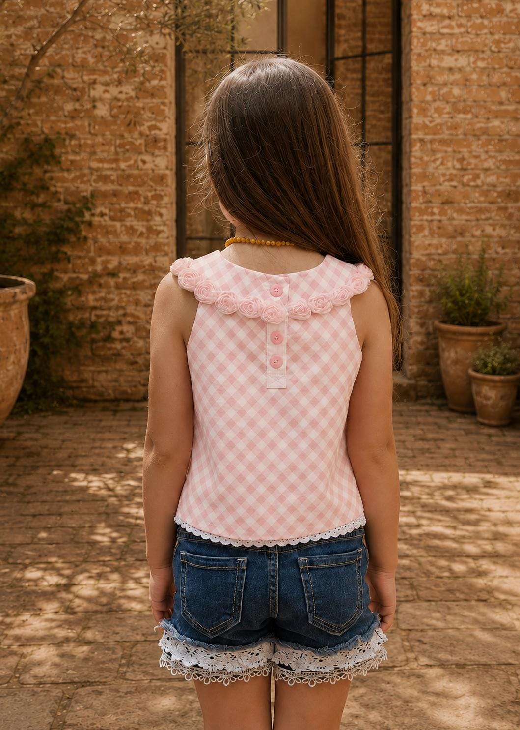Frocks & Frolics Kitty top sewing pattern – back view of pink gingham top with rosette collar and button placket