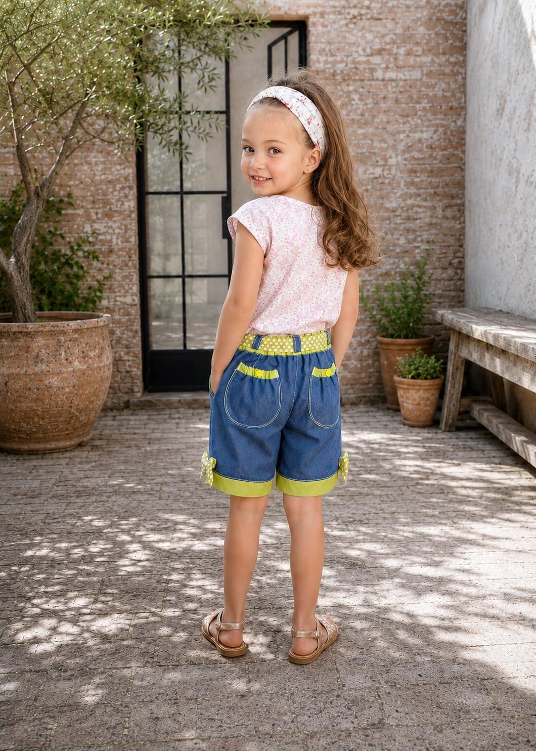 Frocks & Frolics Maisy shorts sewing pattern – back view of denim shorts with lime polka dot pocket trim