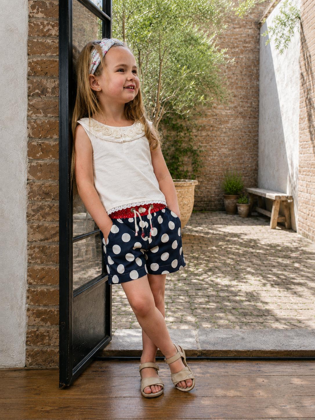 Frocks & Frolics Maisy shorts sewing pattern – navy polka dot shorts with red spotted waistband and drawstring