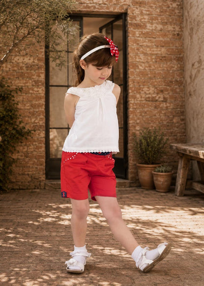 Frocks & Frolics Maisy shorts sewing pattern – back view of red shorts with polka dot pocket trim
