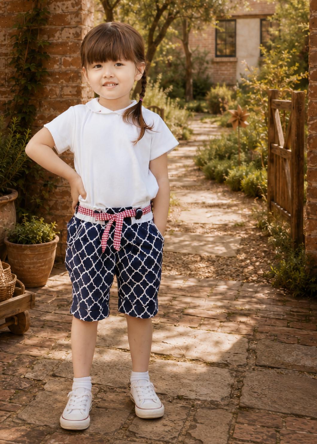 Frocks & Frolics Maisy shorts sewing pattern – navy quatrefoil print shorts with red gingham tie belt