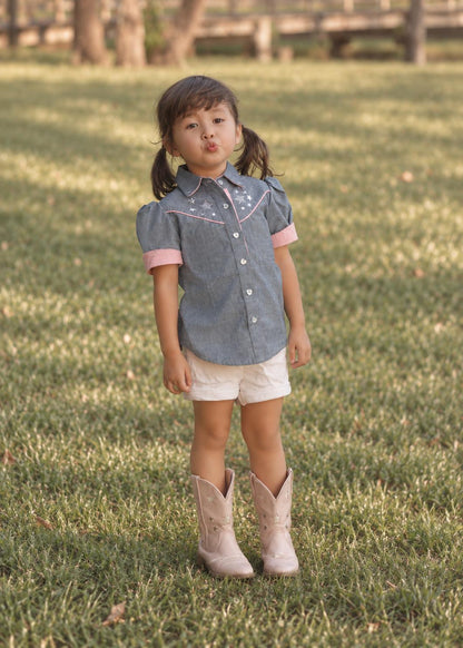 Frocks & Frolics Western Blouse sewing pattern – denim blouse with pink trim and star embroidery, with cowboy boots