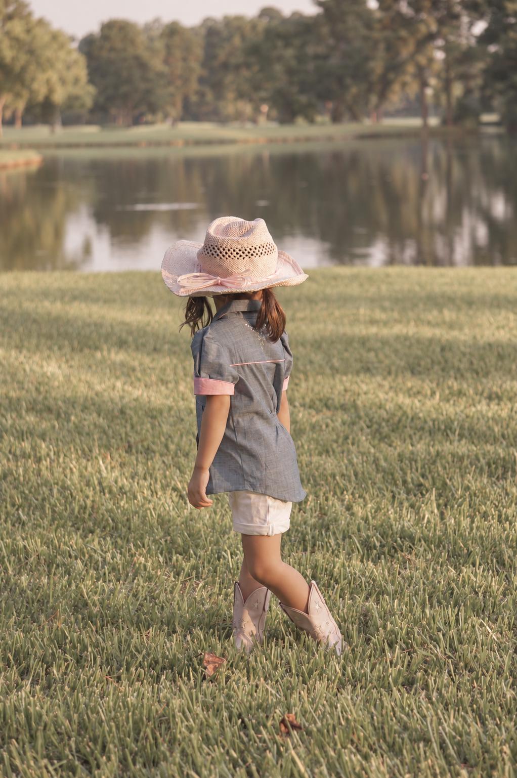 Frocks & Frolics Western Blouse sewing pattern – back view of blouse with pink trim and straw cowboy hat