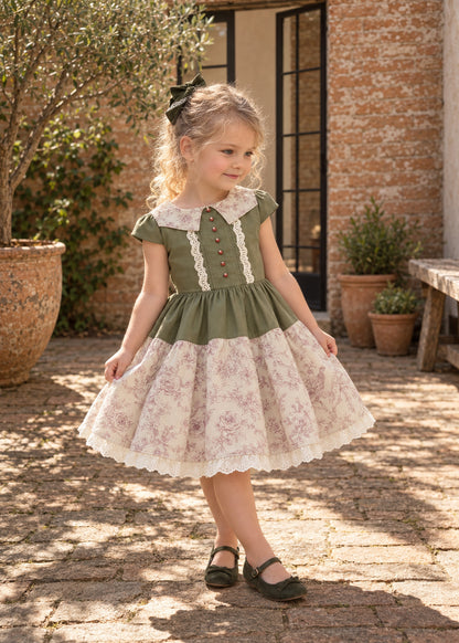 Isabella Dress PDF sewing pattern. Little girl in a dress with a green pin-tucked bodice, white collar, puff sleeves and a gathered pink floral skirt with lace hem.