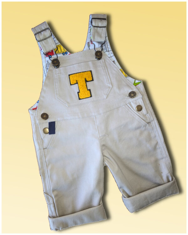 Baby Dazzler overalls dungarees. Sewing pattern by Frocks & Frolics with free video tutorial. Includes leg opening for nappy changes, side pockets, patch pocket details and faux zipper front.